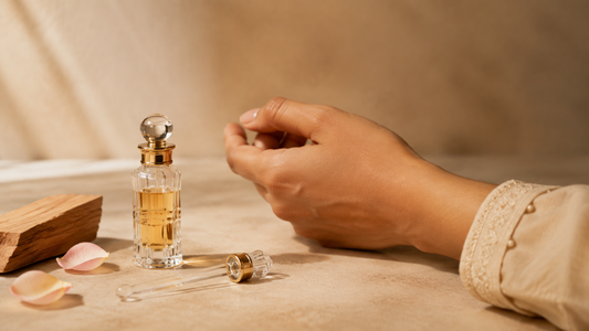 Applying attar carefully to the wrist beside a traditional glass attar bottle
